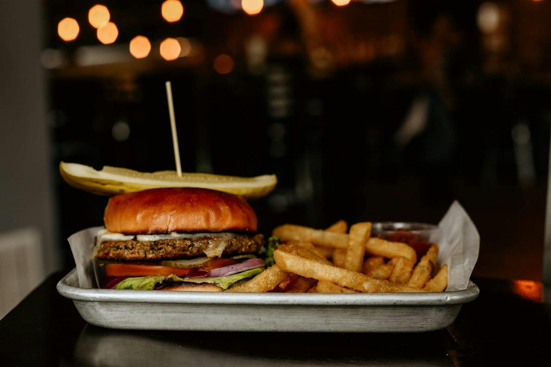 a plate with a burger and fries on a table