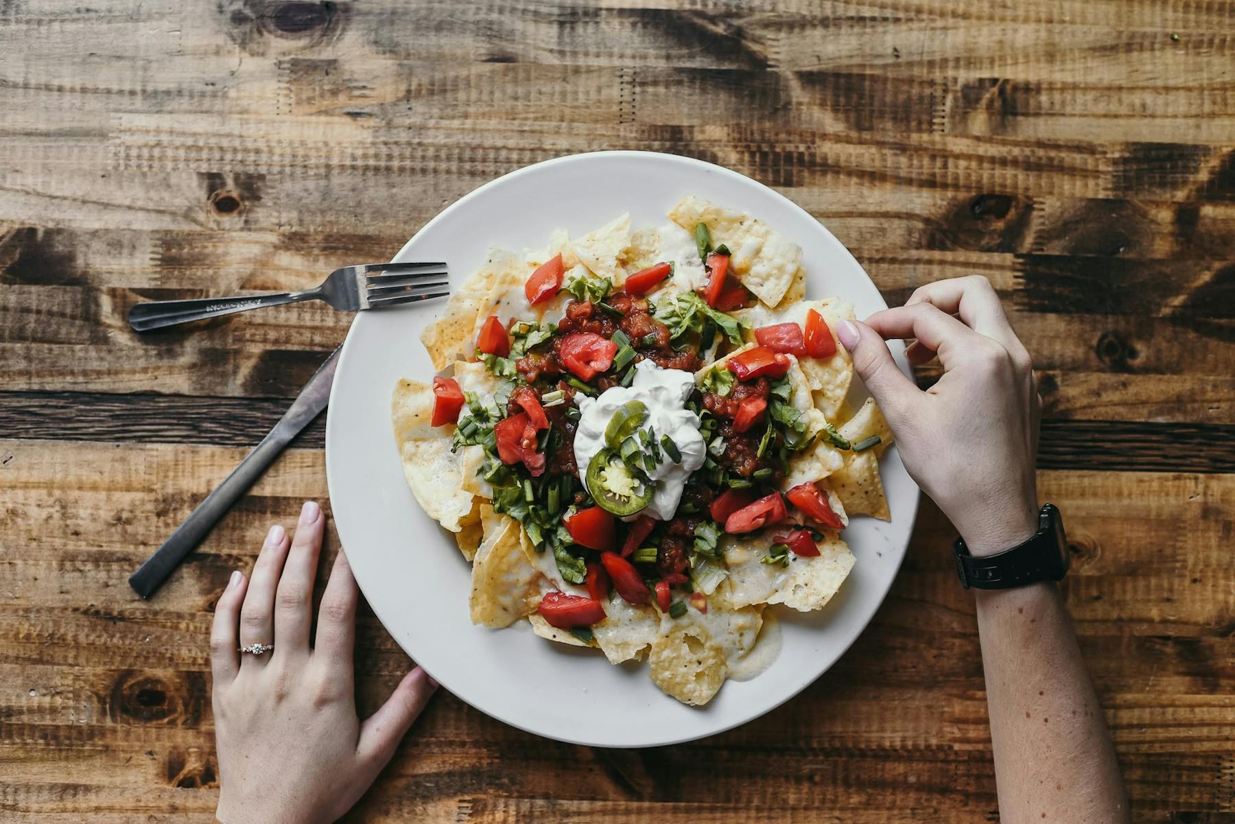 a person eating nachos