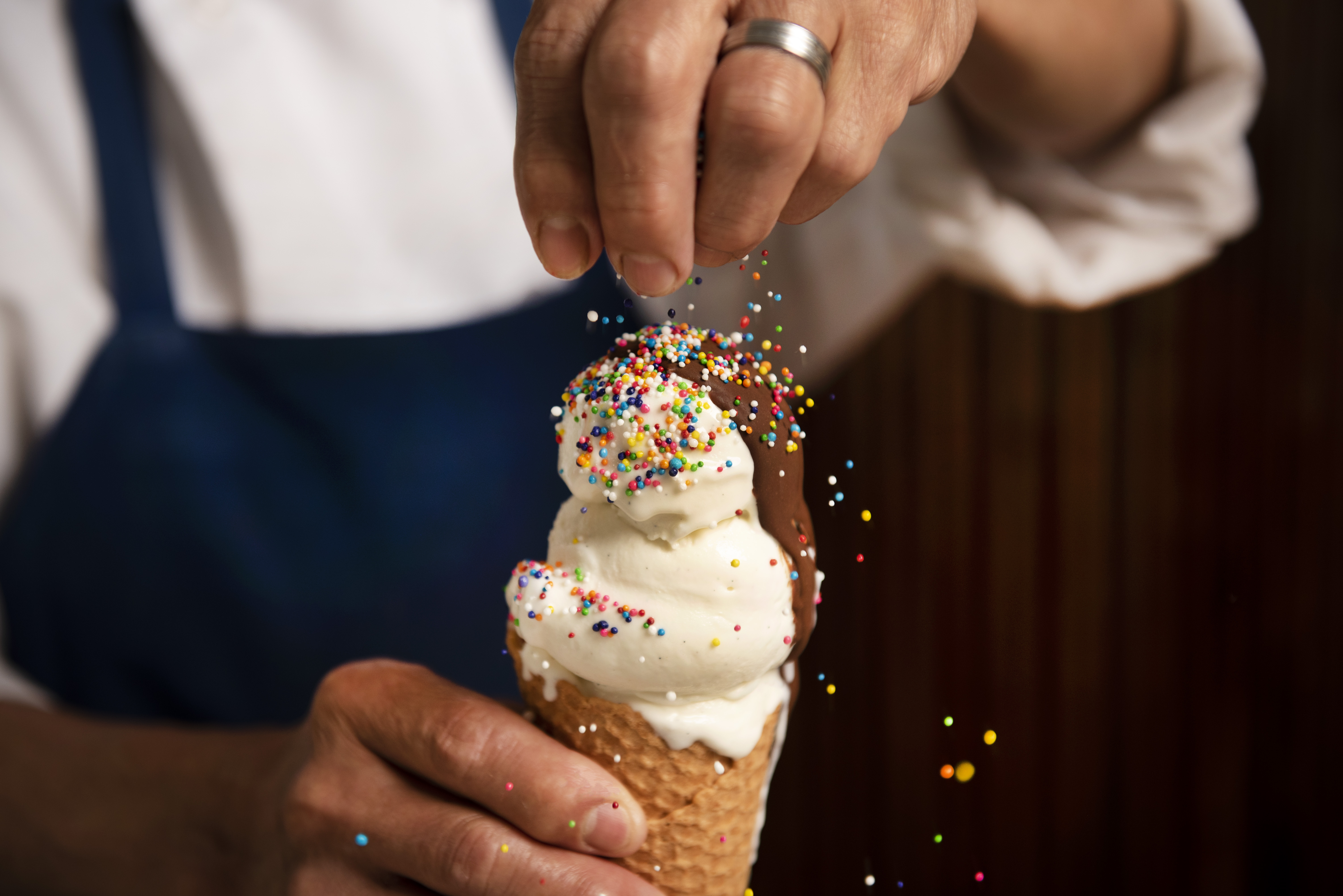 a hand holding a piece of cake