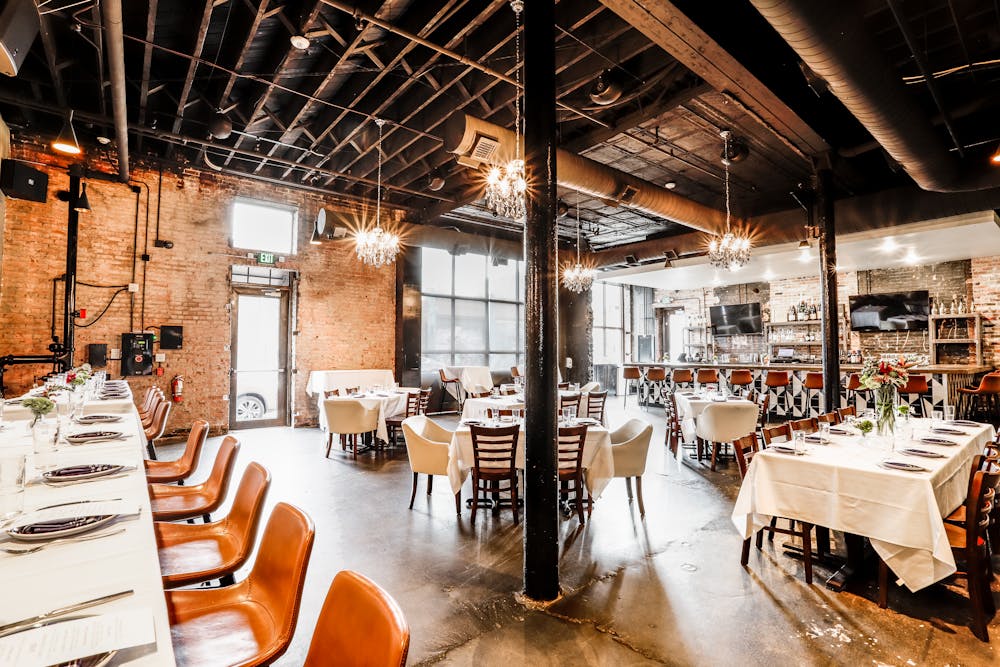a room filled with furniture and a table in front of a building