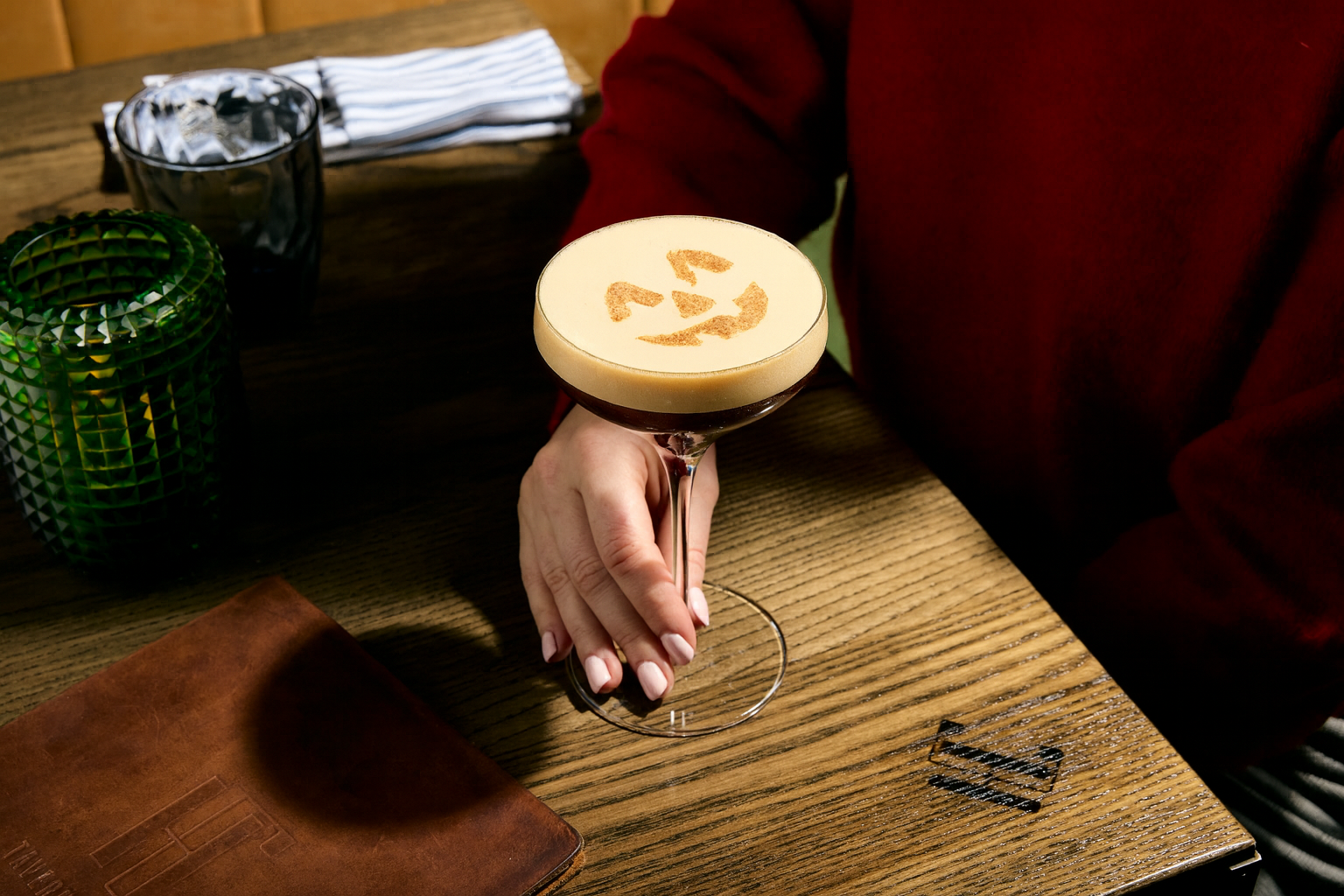 a hand holding a drink