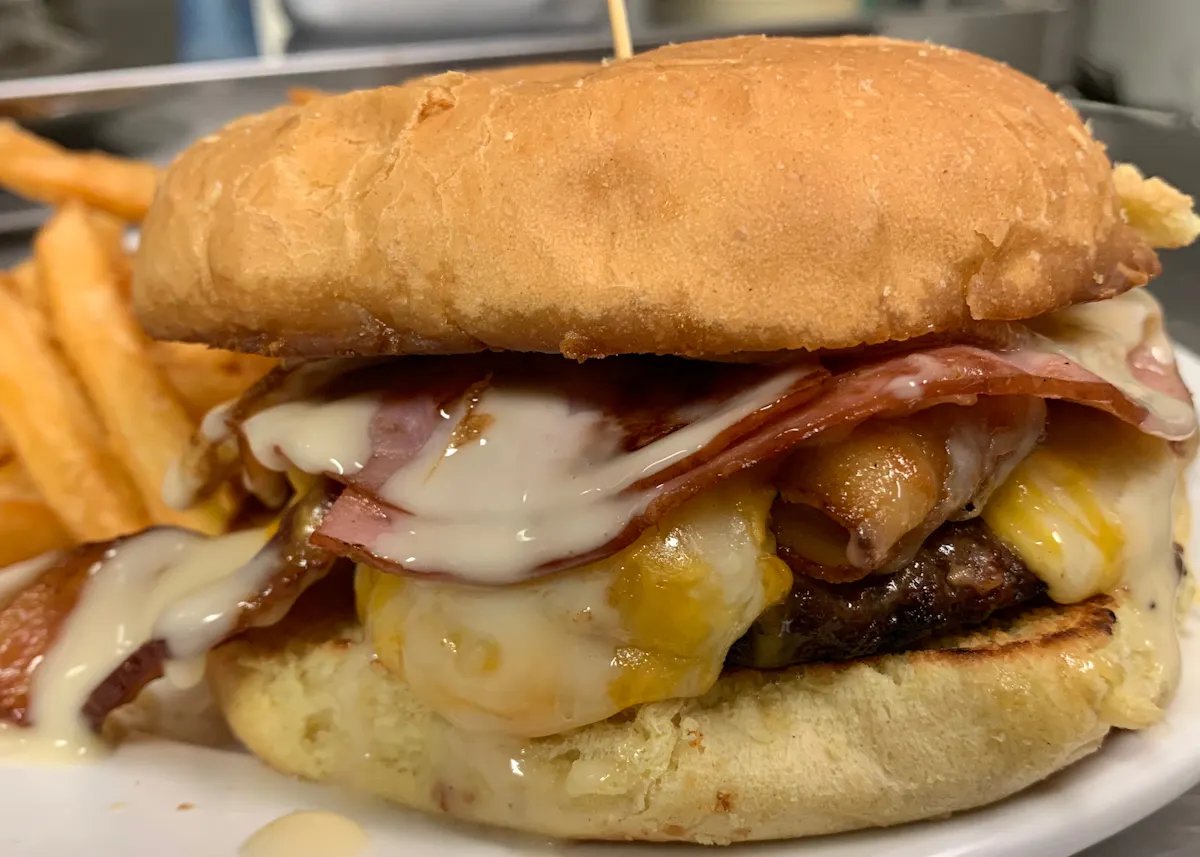 a close up of a sandwich and fries on a plate