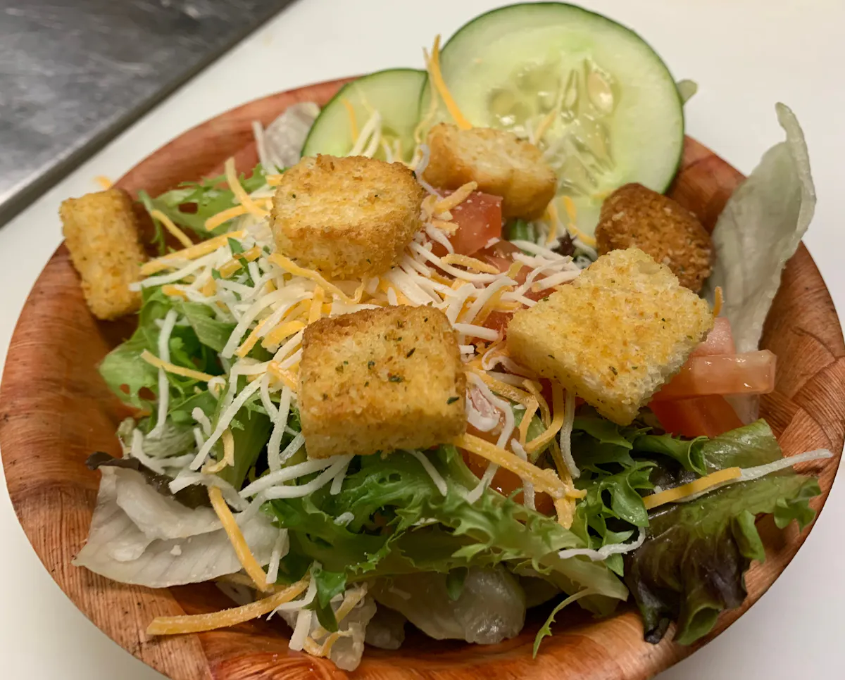 a plate of food with a sandwich and a salad