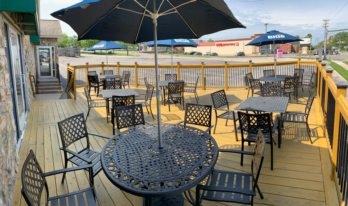 a group of lawn chairs sitting on a chair under an umbrella