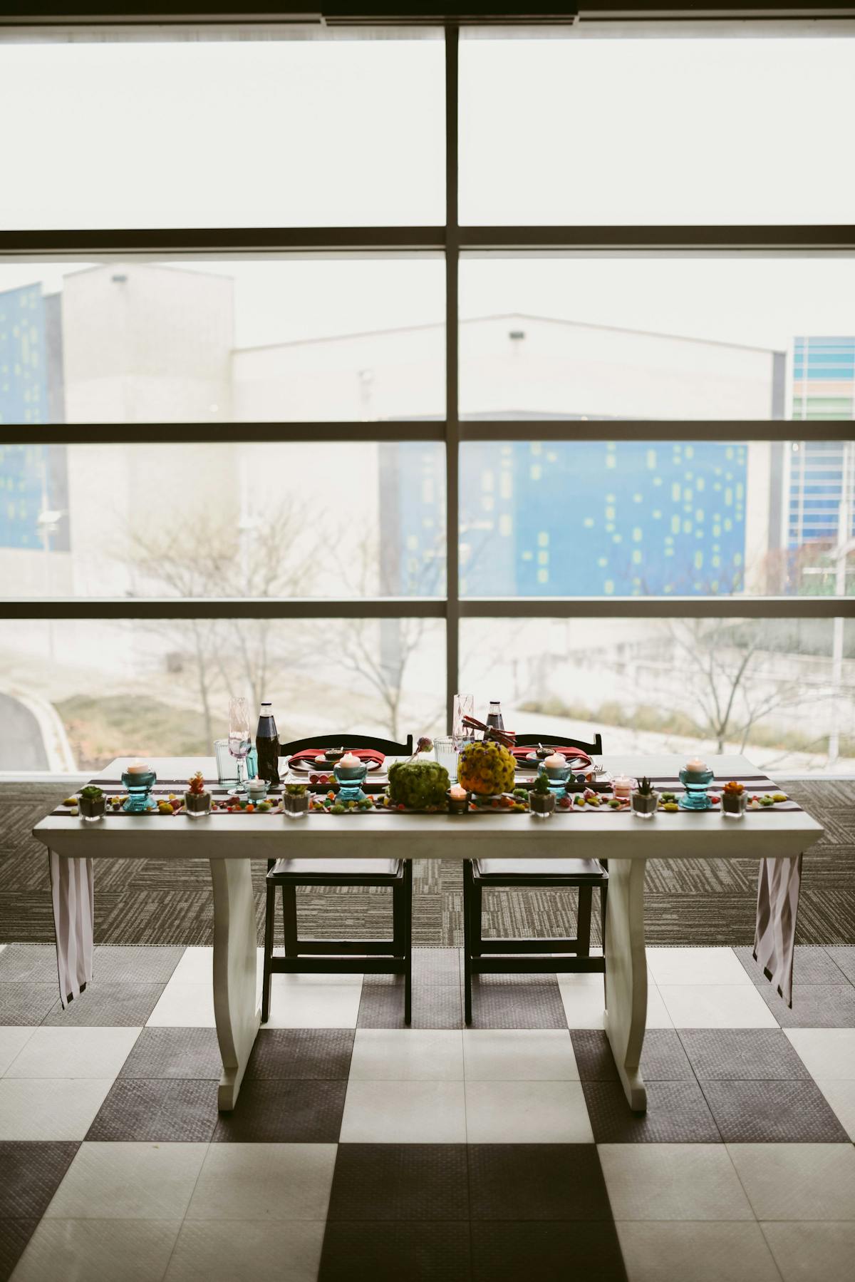 a kitchen with a table in front of a window