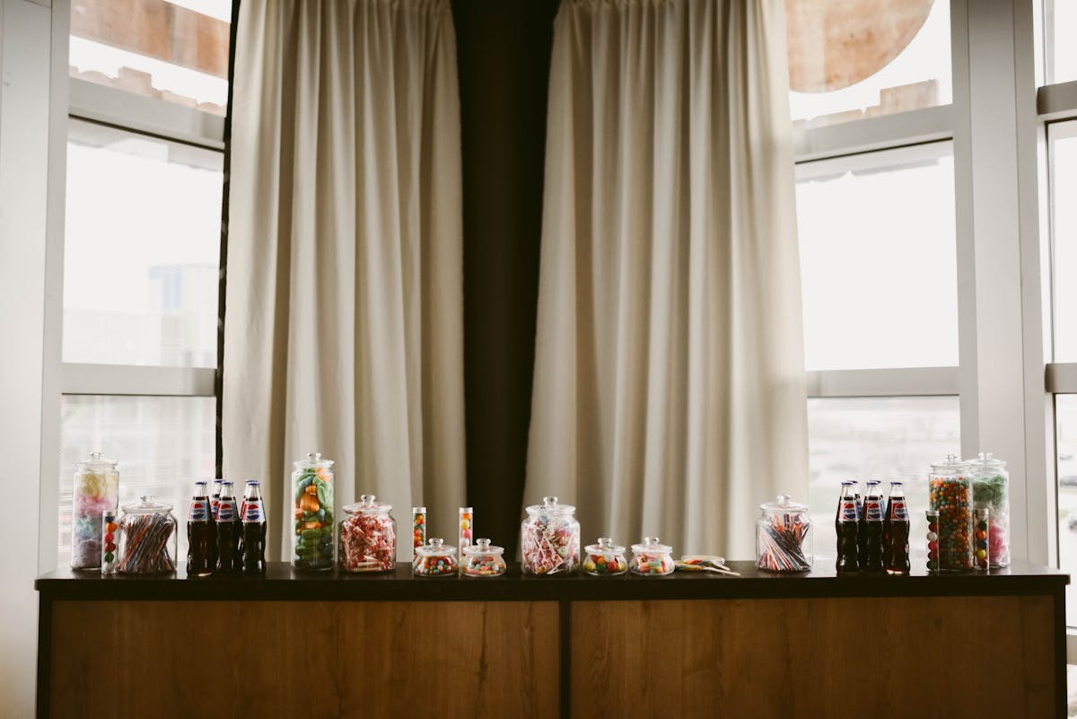 a vase of flowers on a table next to a window