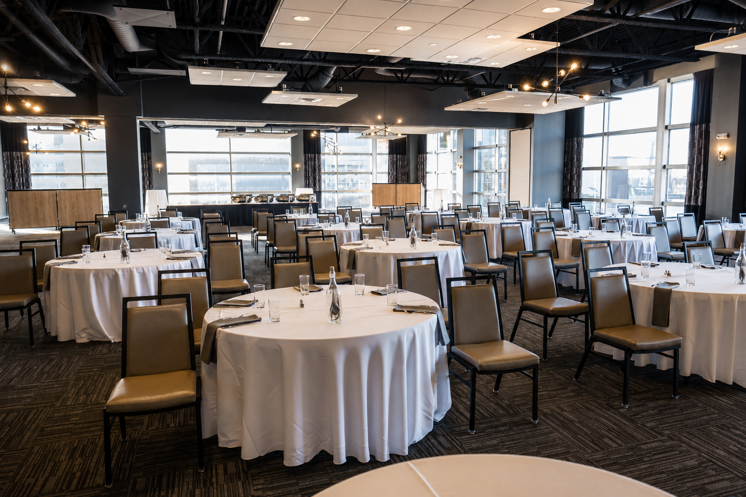 Corporate event setup with tables and chairs at the CRG Event Center