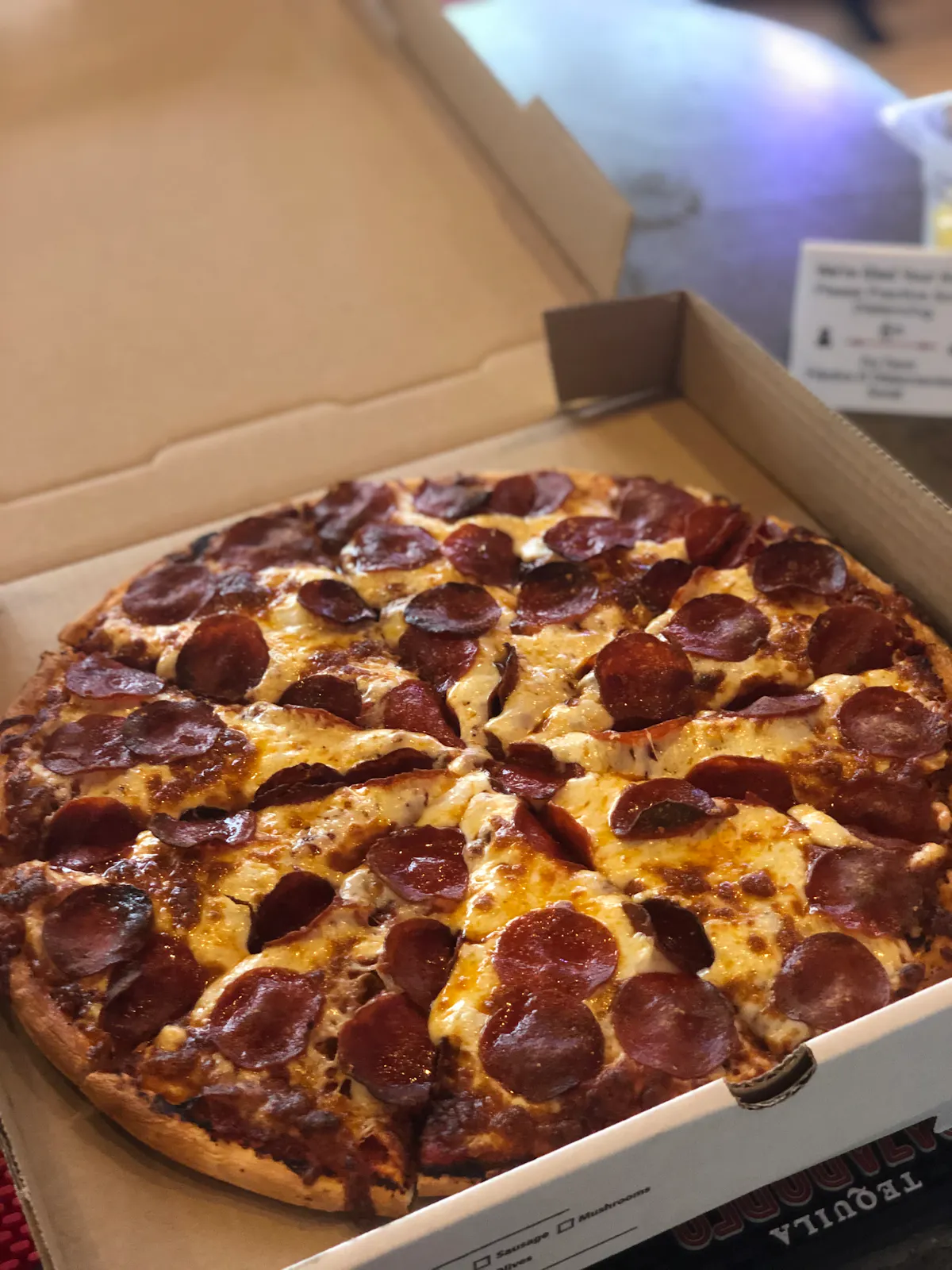 a pizza sitting on top of a box