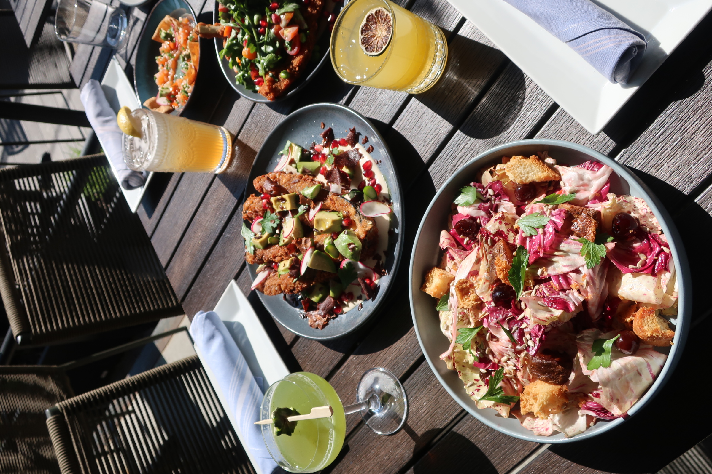 a table with plates of food and drinks