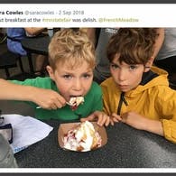 a group of young children sitting next to a child