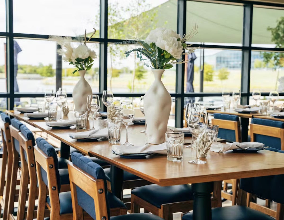 a dining room table in front of a window