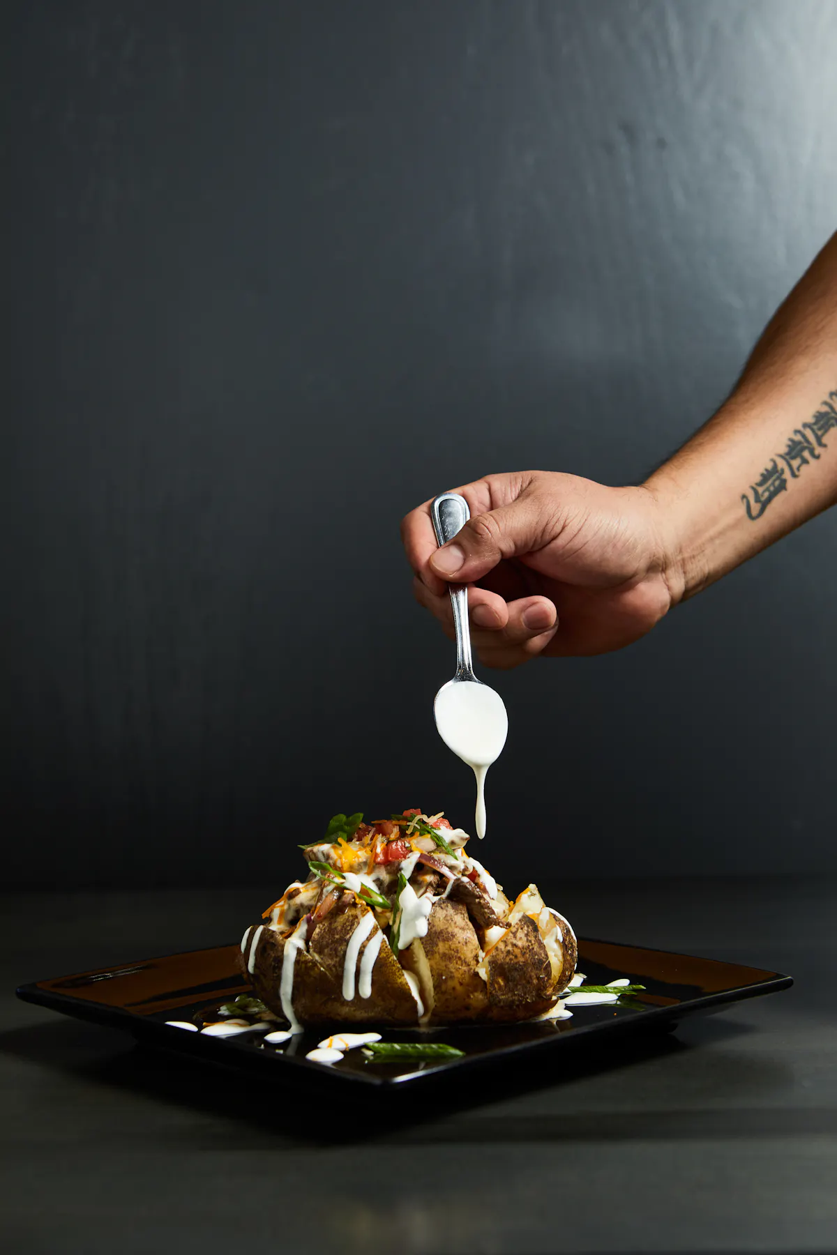 a hand holding a glass bowl on a table