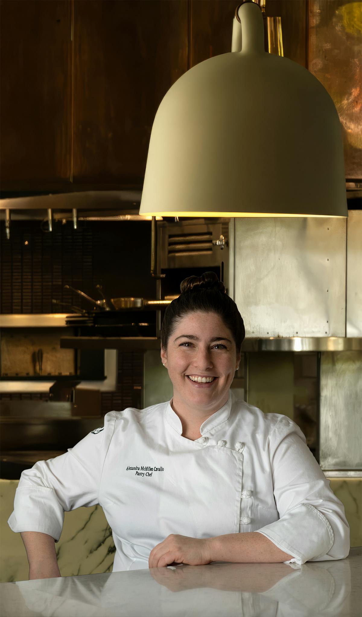 a female sitting in a kitchen