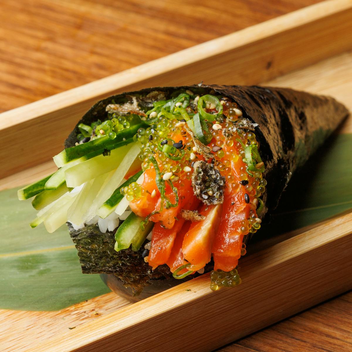 a piece of broccoli on a wooden cutting board