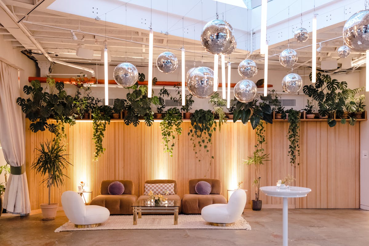 a room filled with furniture and a fireplace and hanging disco balls
