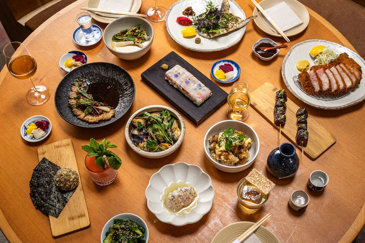 a wooden table topped with plates of food