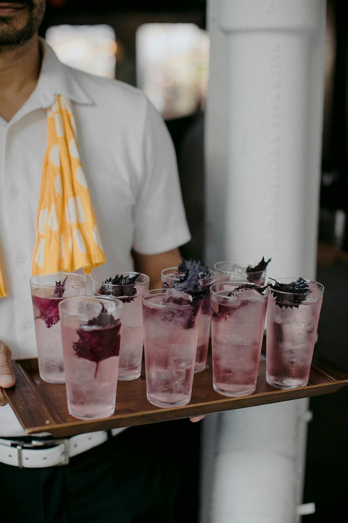 man holding a plate of drinks