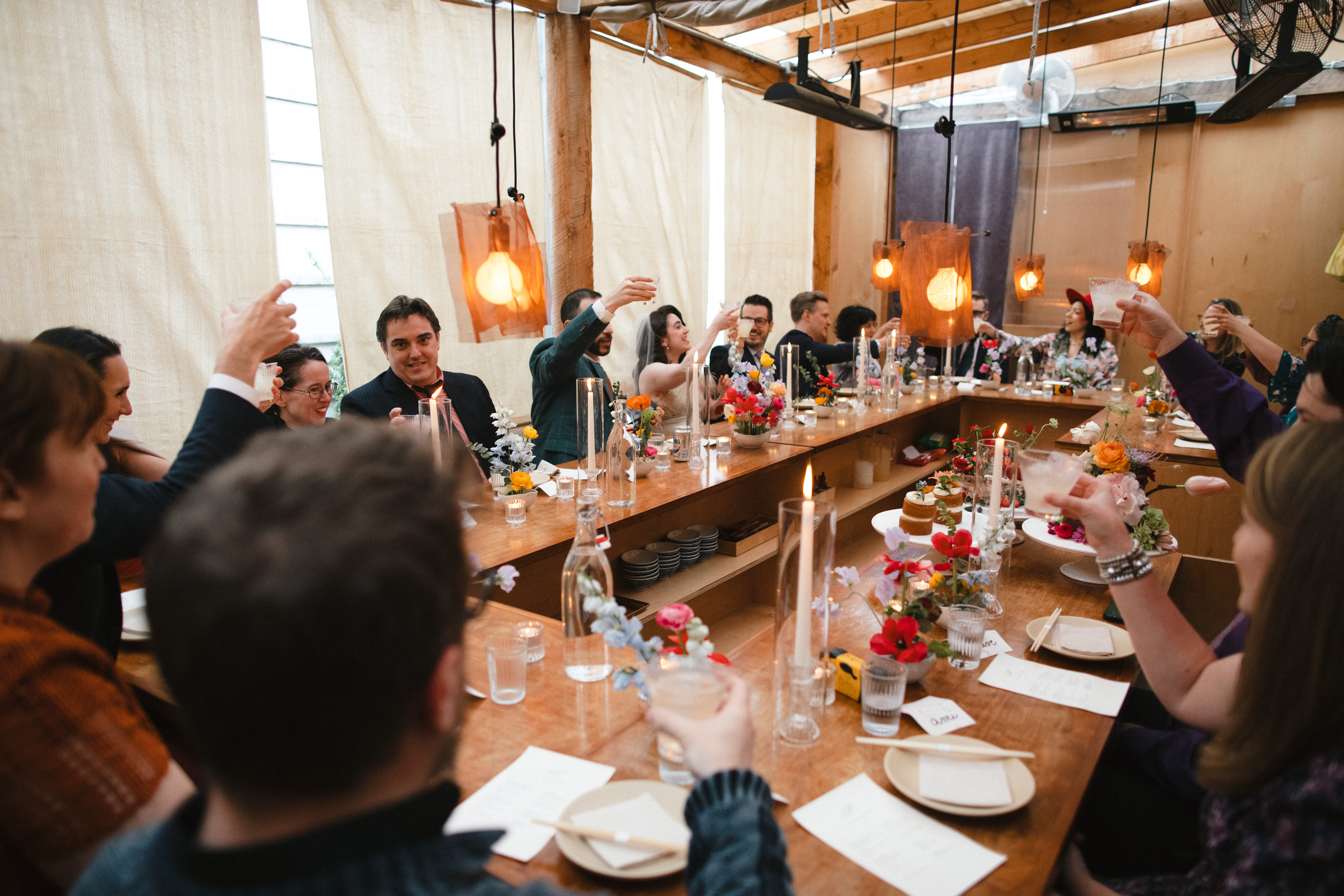 John Coda et al. sitting at a table with wine glasses