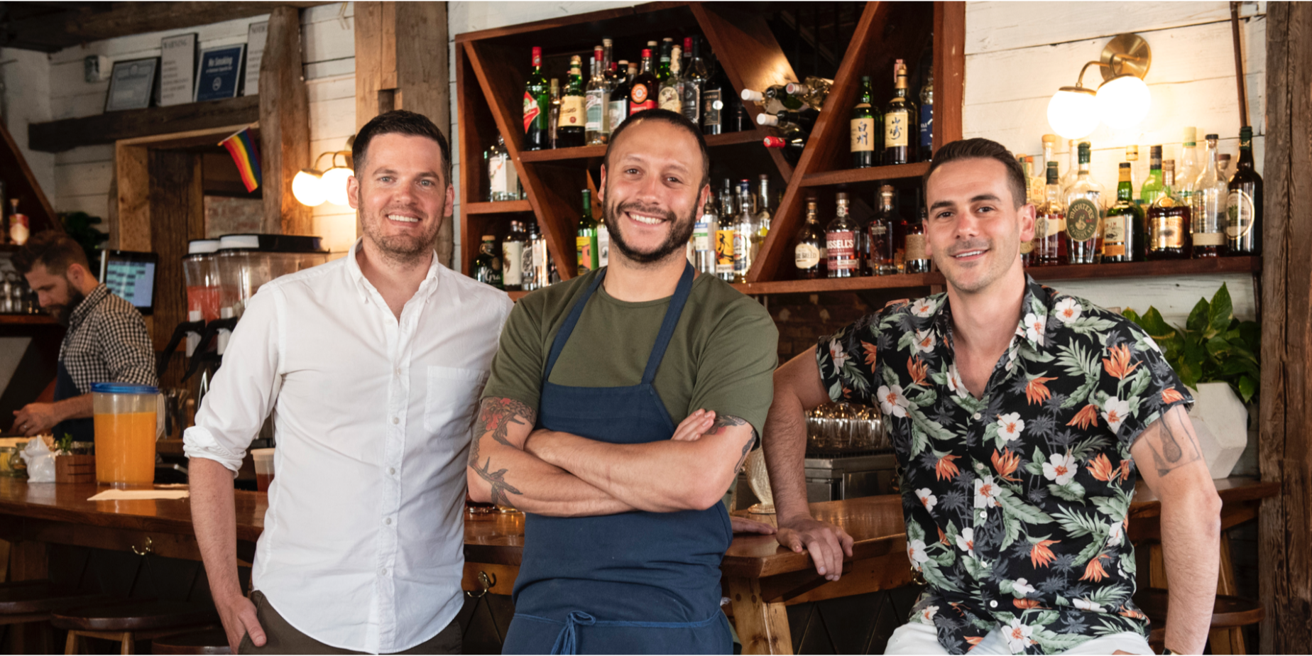 a group of people standing in a kitchen