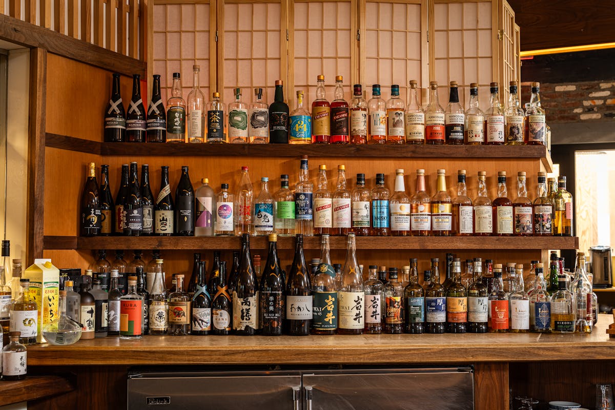 a row of wine glasses on a shelf
