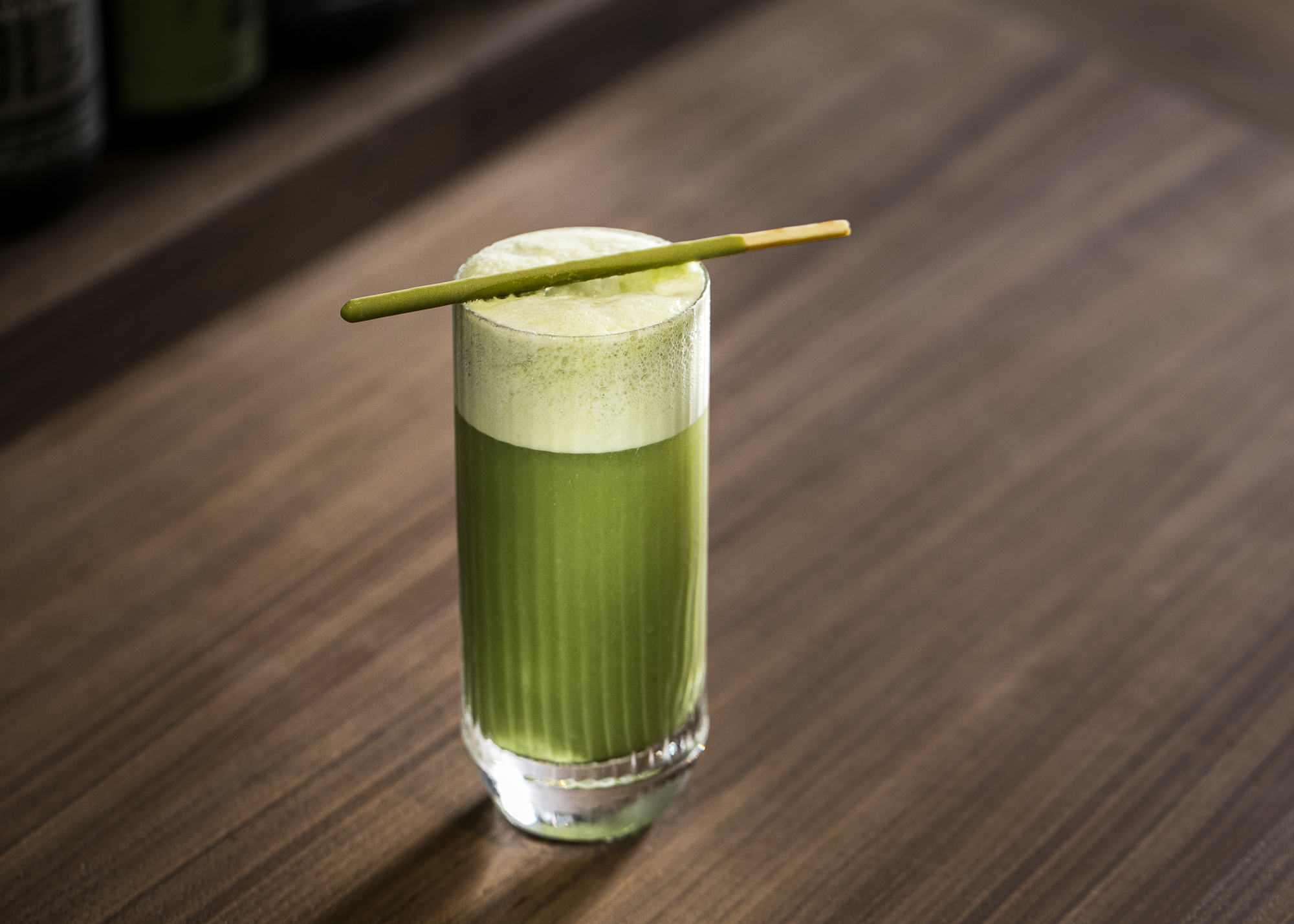 a glass filled with green juice