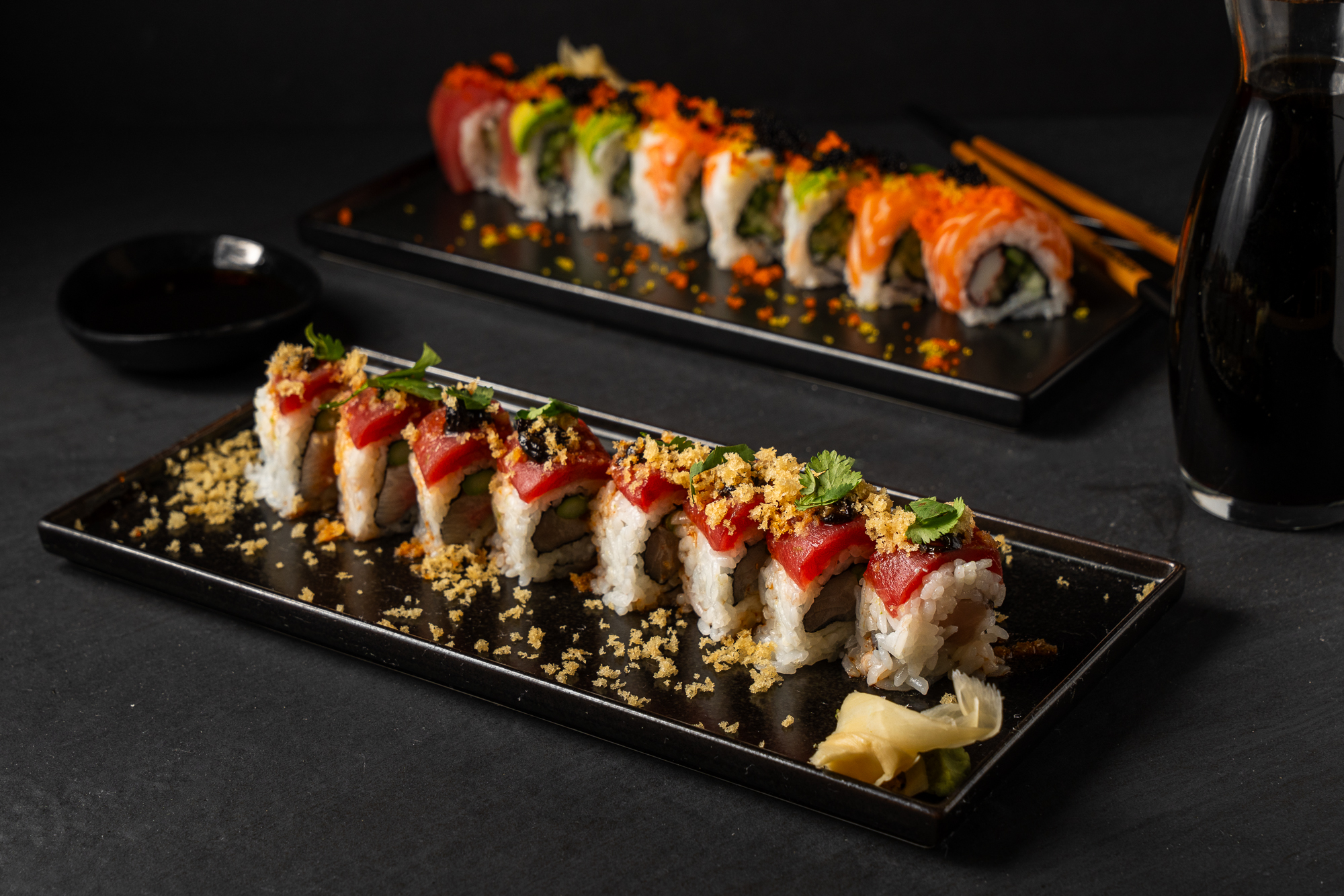 a plate of sushi on a black surface