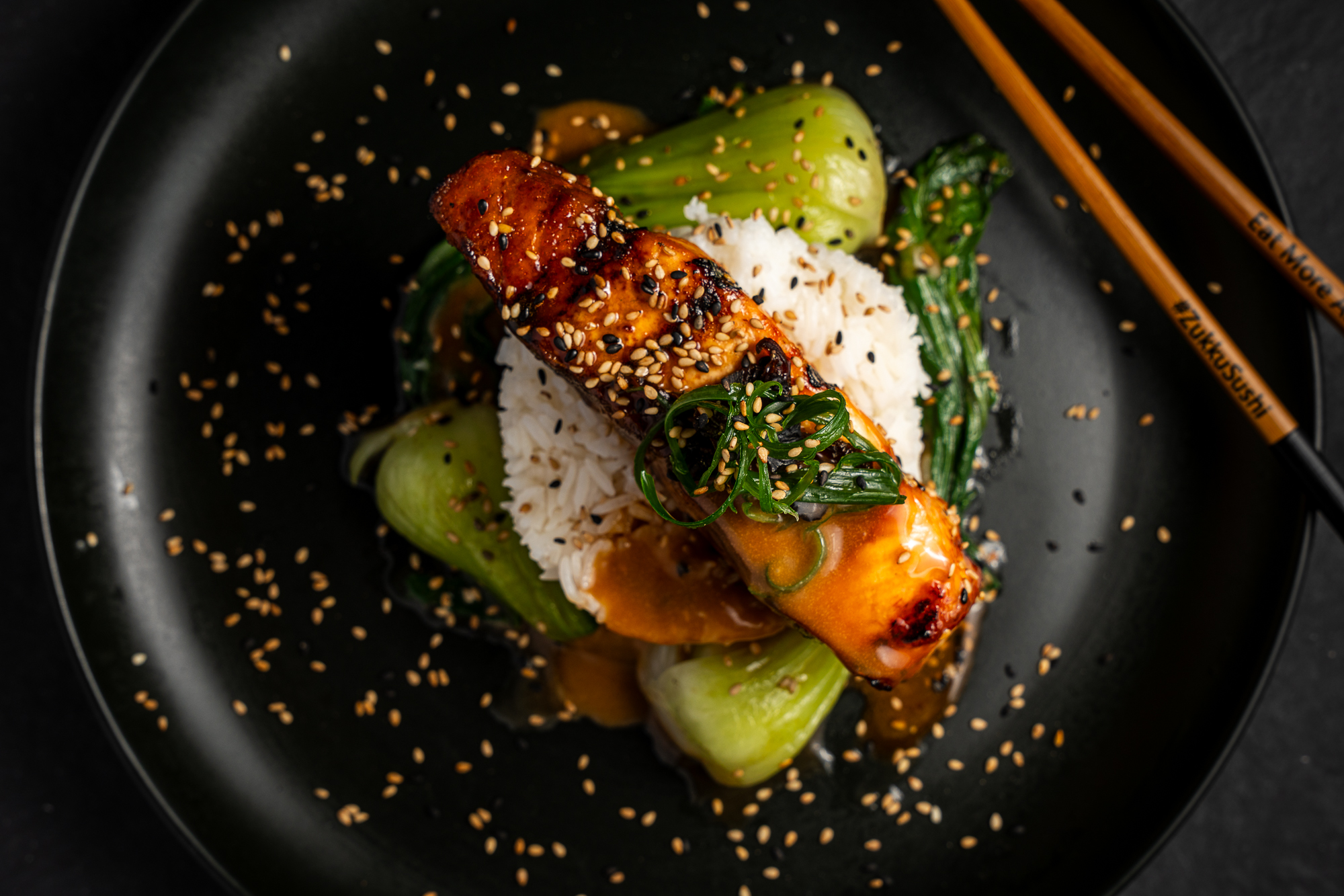 a plate of food with chopsticks