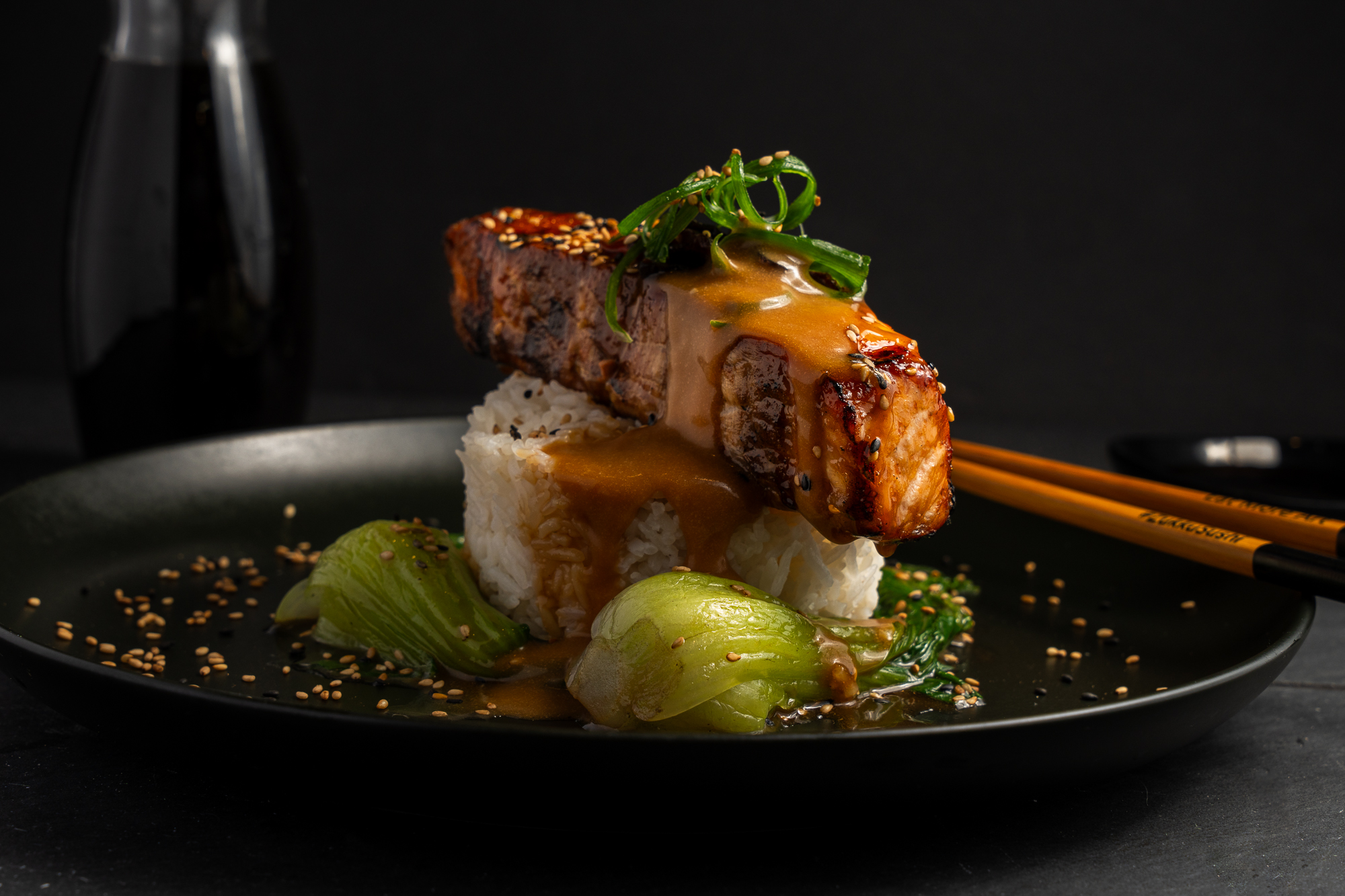 a plate of food with chopsticks