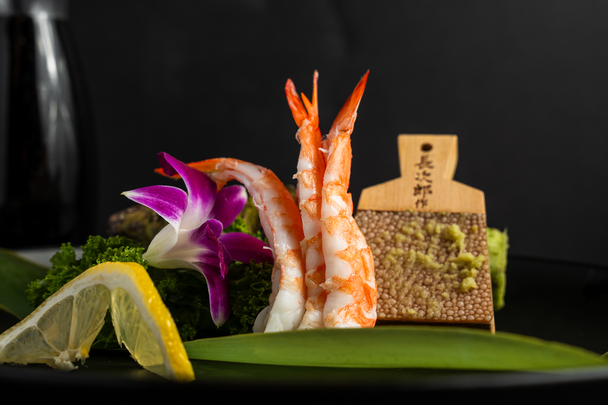 a plate of food with a flower and a piece of food on it