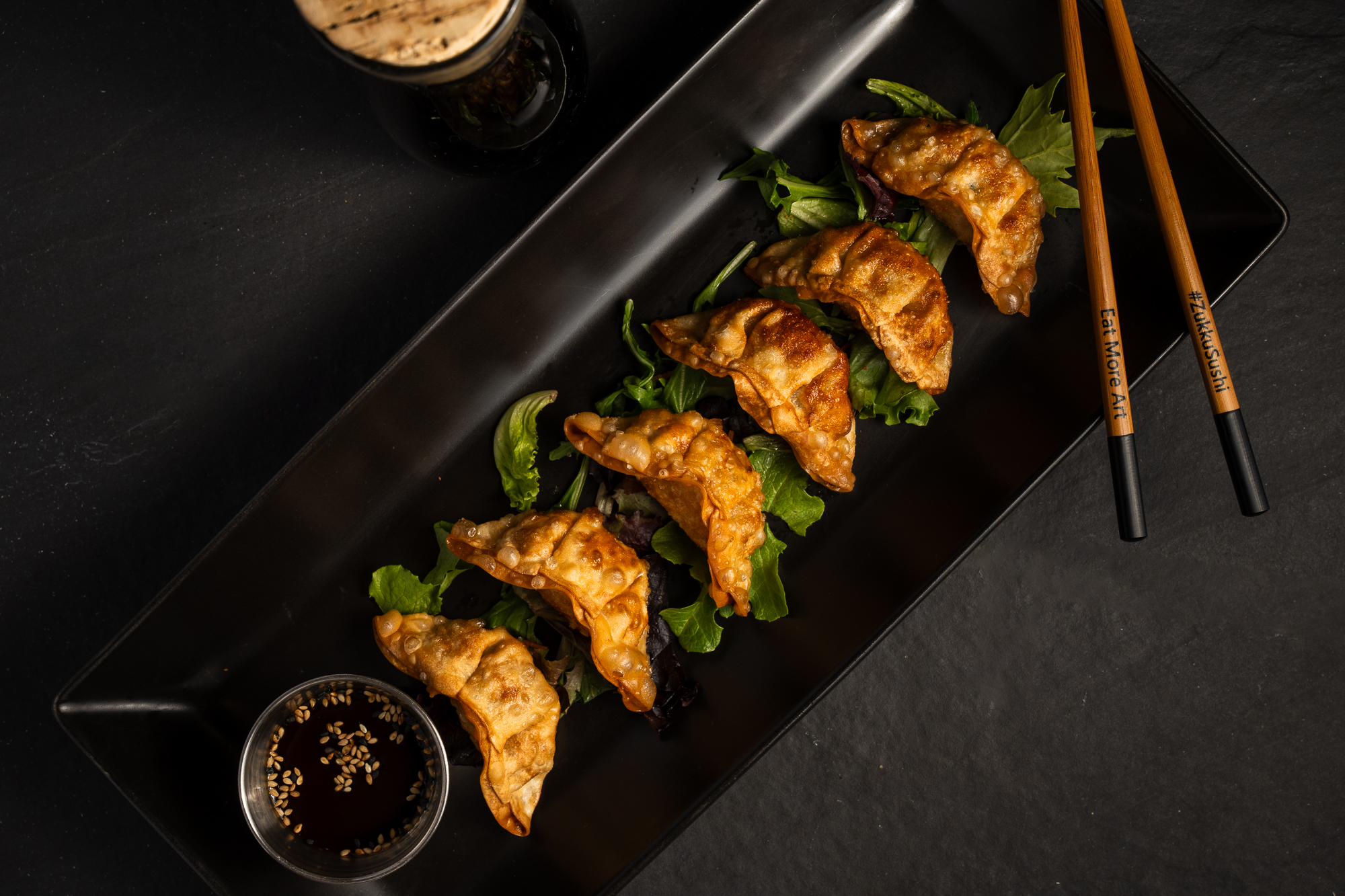 a plate of fried dumplings and sauce