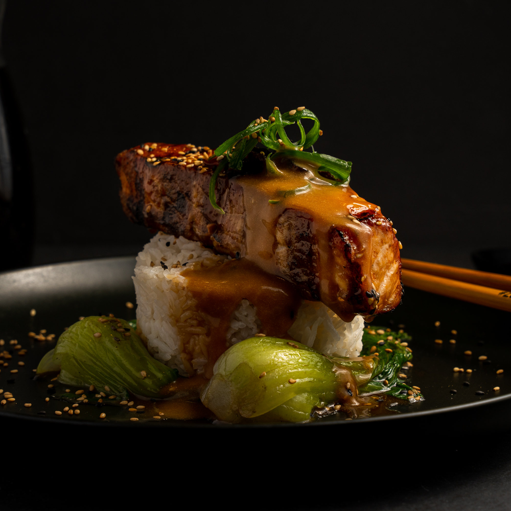 a plate of food with chopsticks