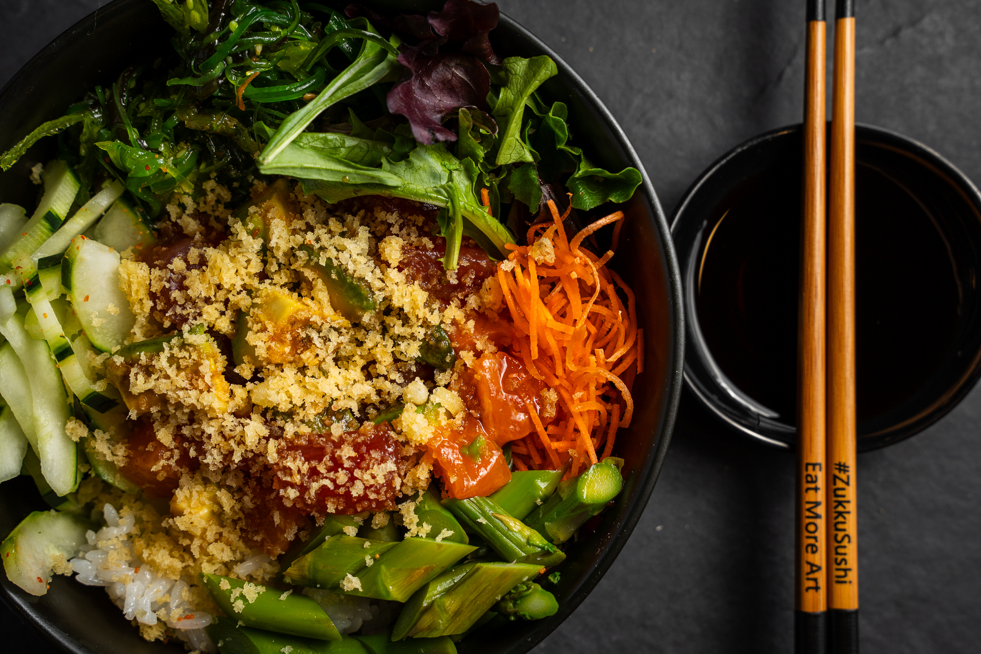 a bowl of food with chopsticks