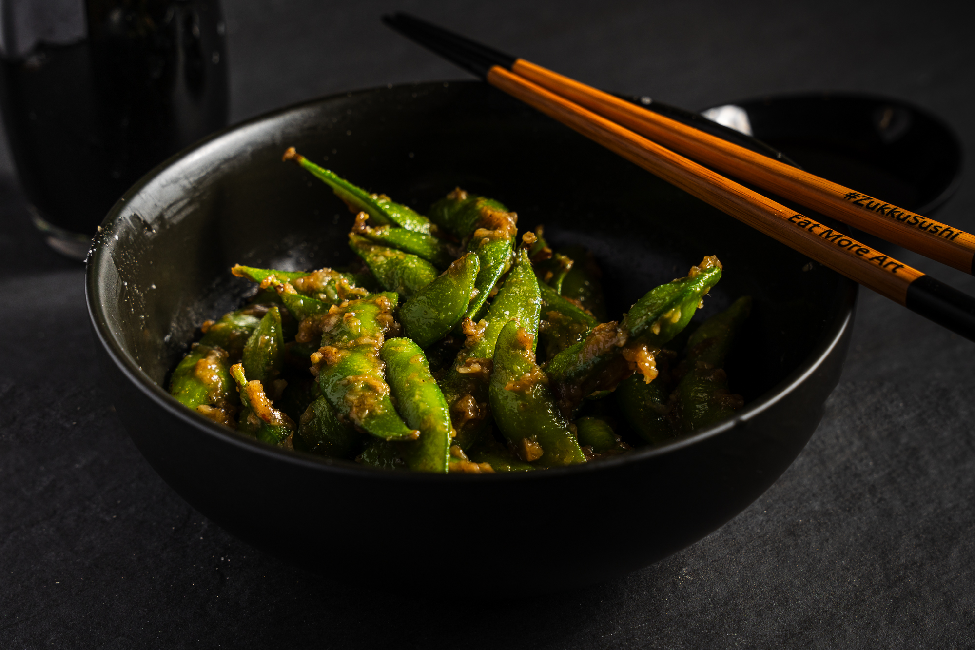 a bowl of food with chopsticks