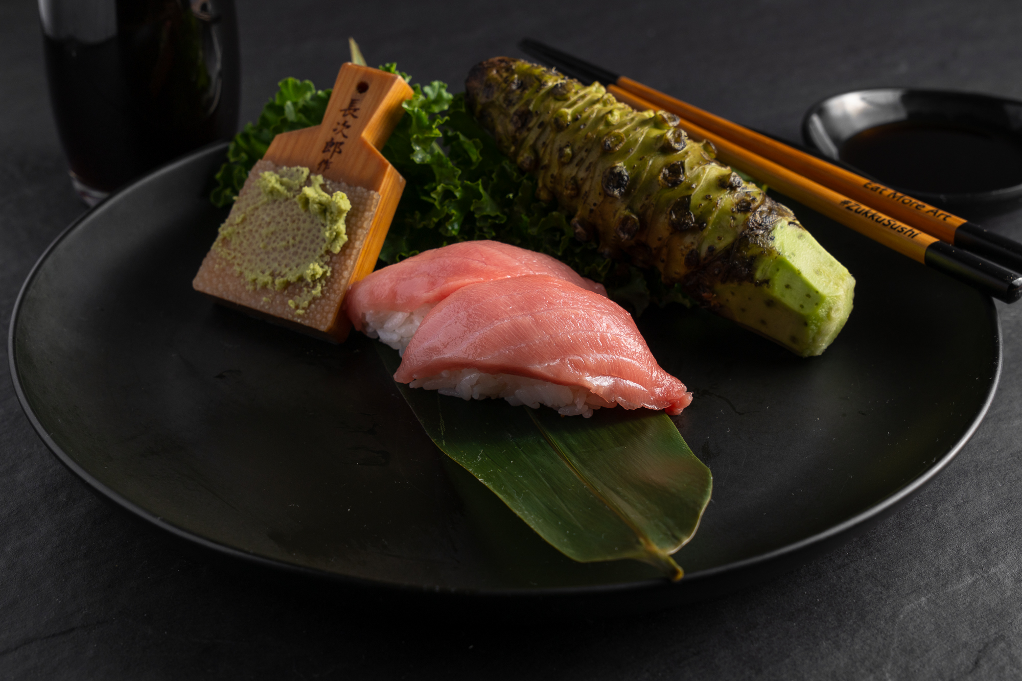 a plate of food with chopsticks and a spoon