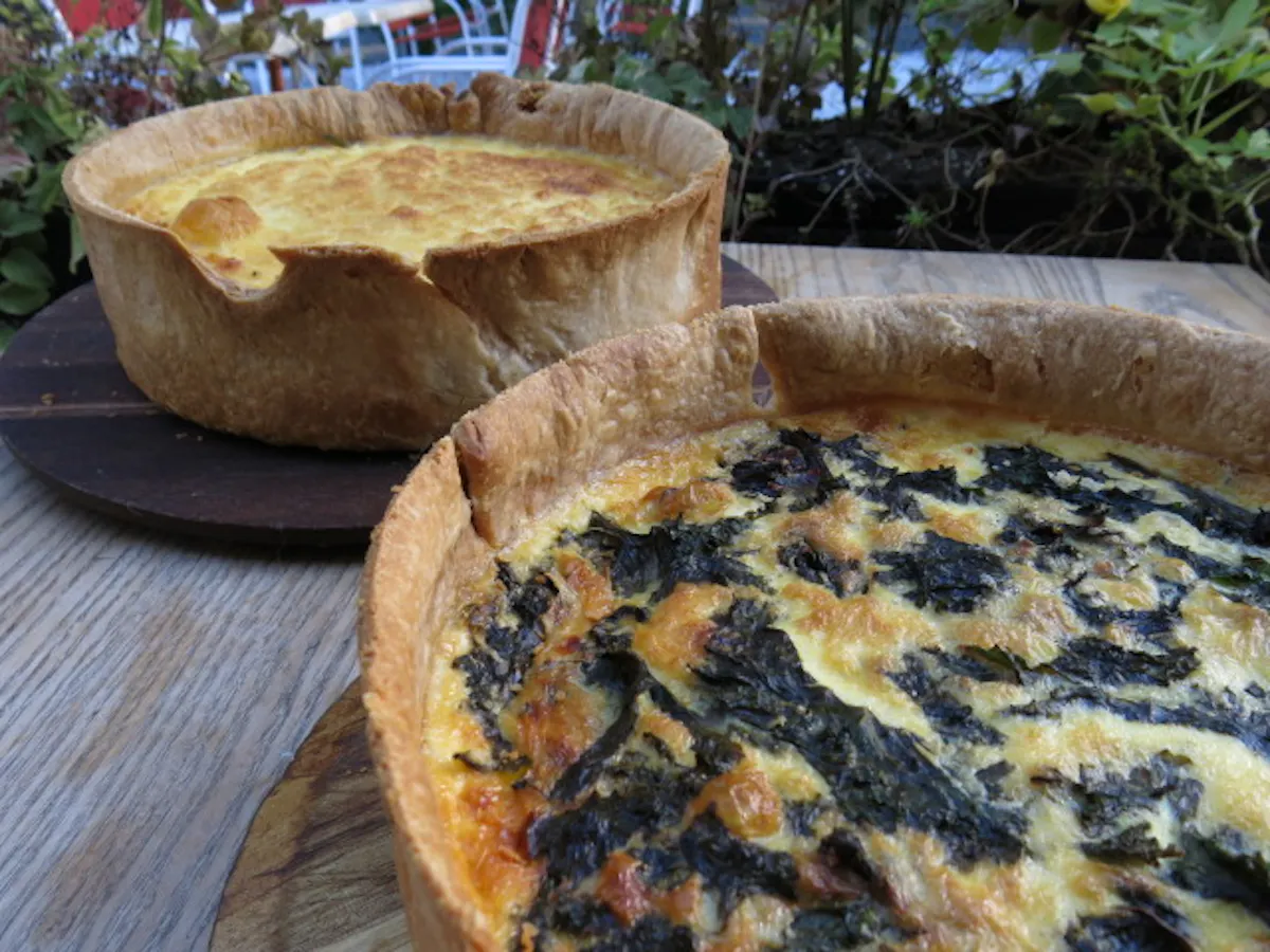 a pizza sitting on top of a wooden table