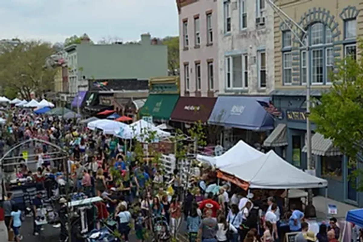 a crowd of people walking down a street