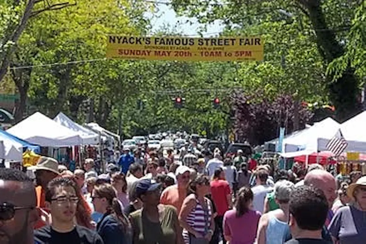 a crowd of people walking down a street