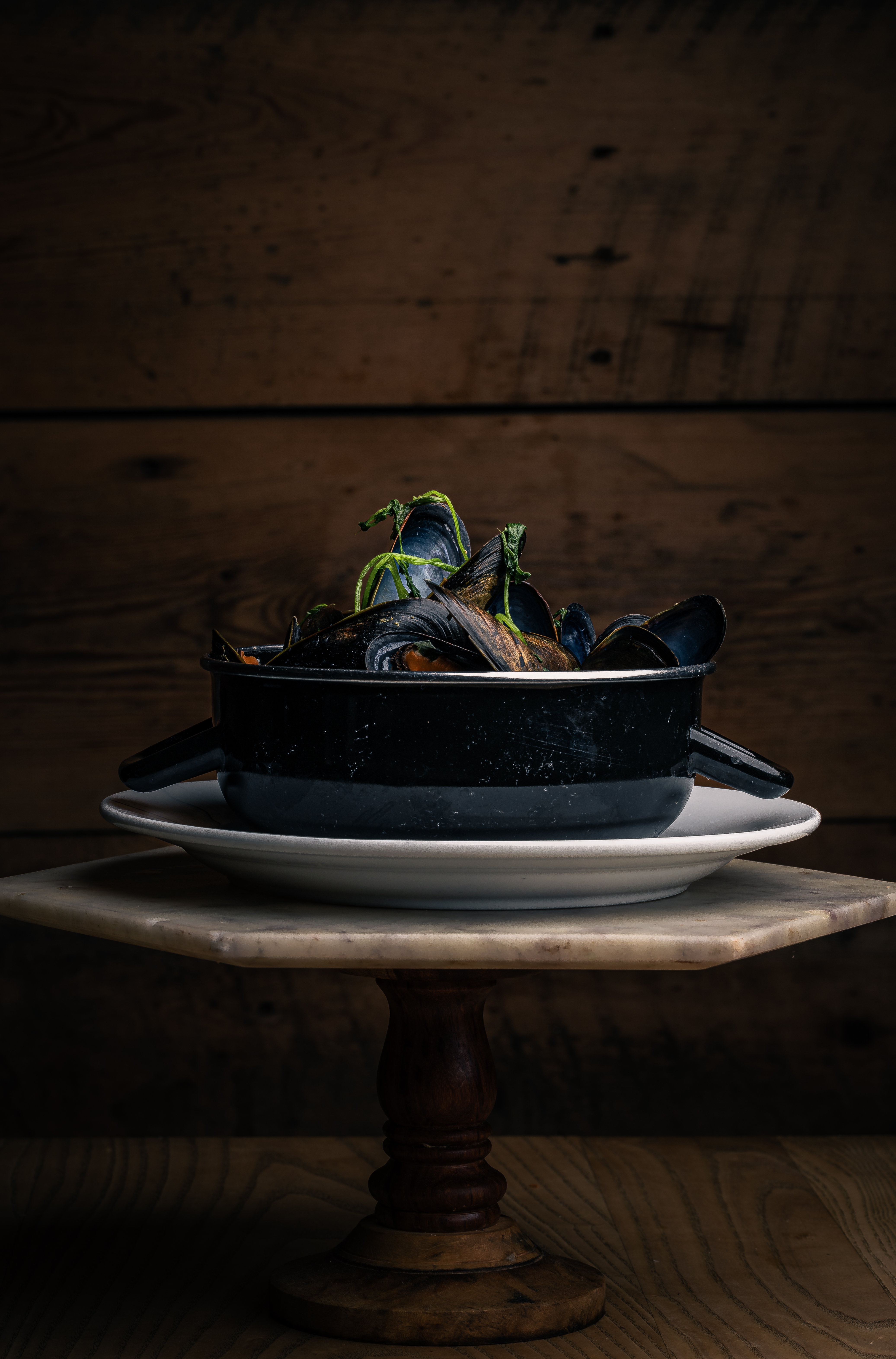 a bowl of fruit sitting on top of a wooden table