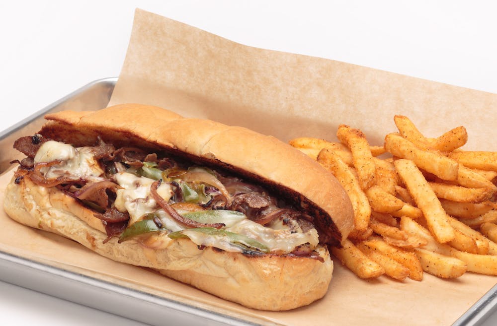 a sandwich is sitting on the side of fries