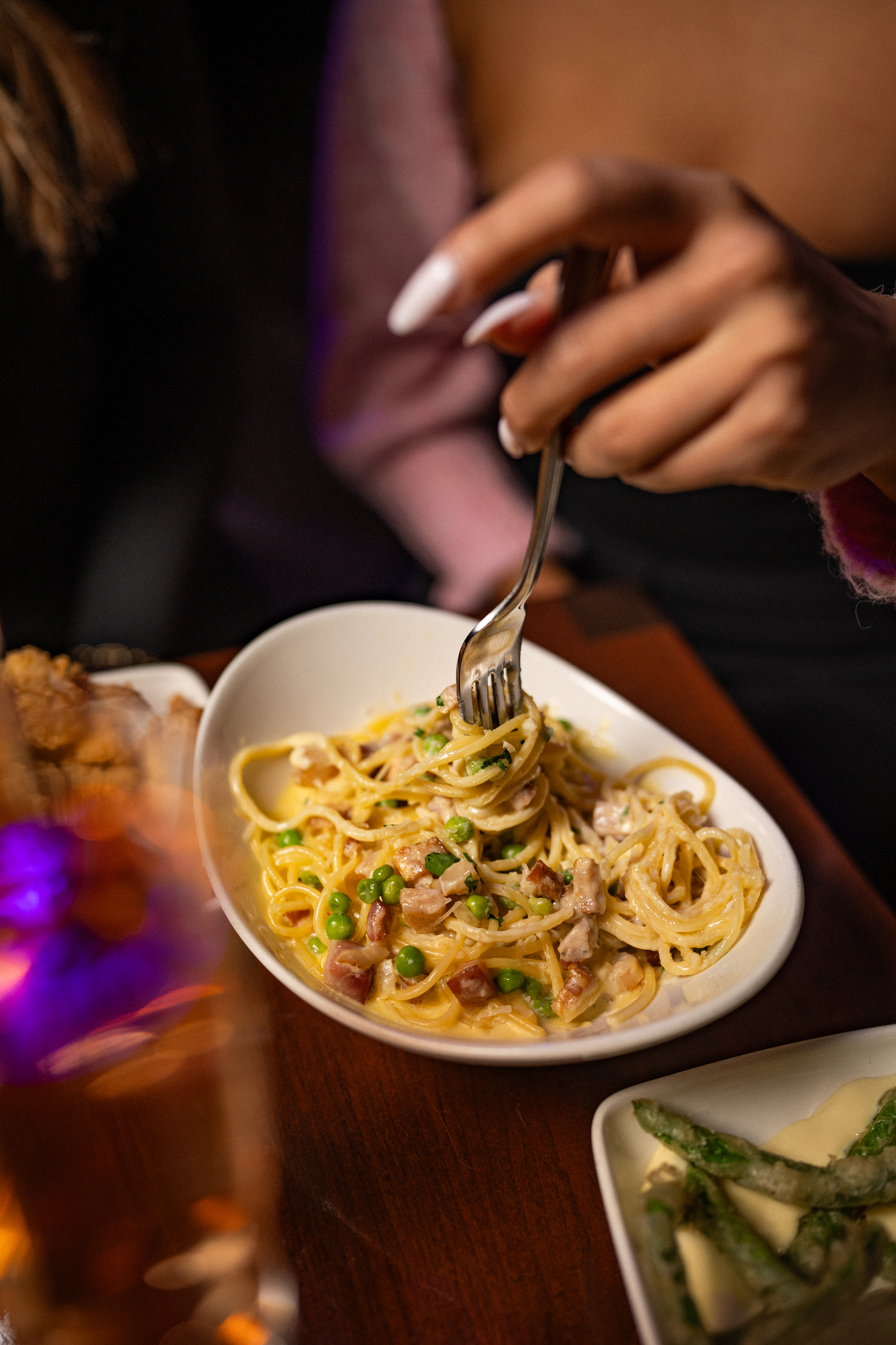 a woman sitting at a table with a plate of food