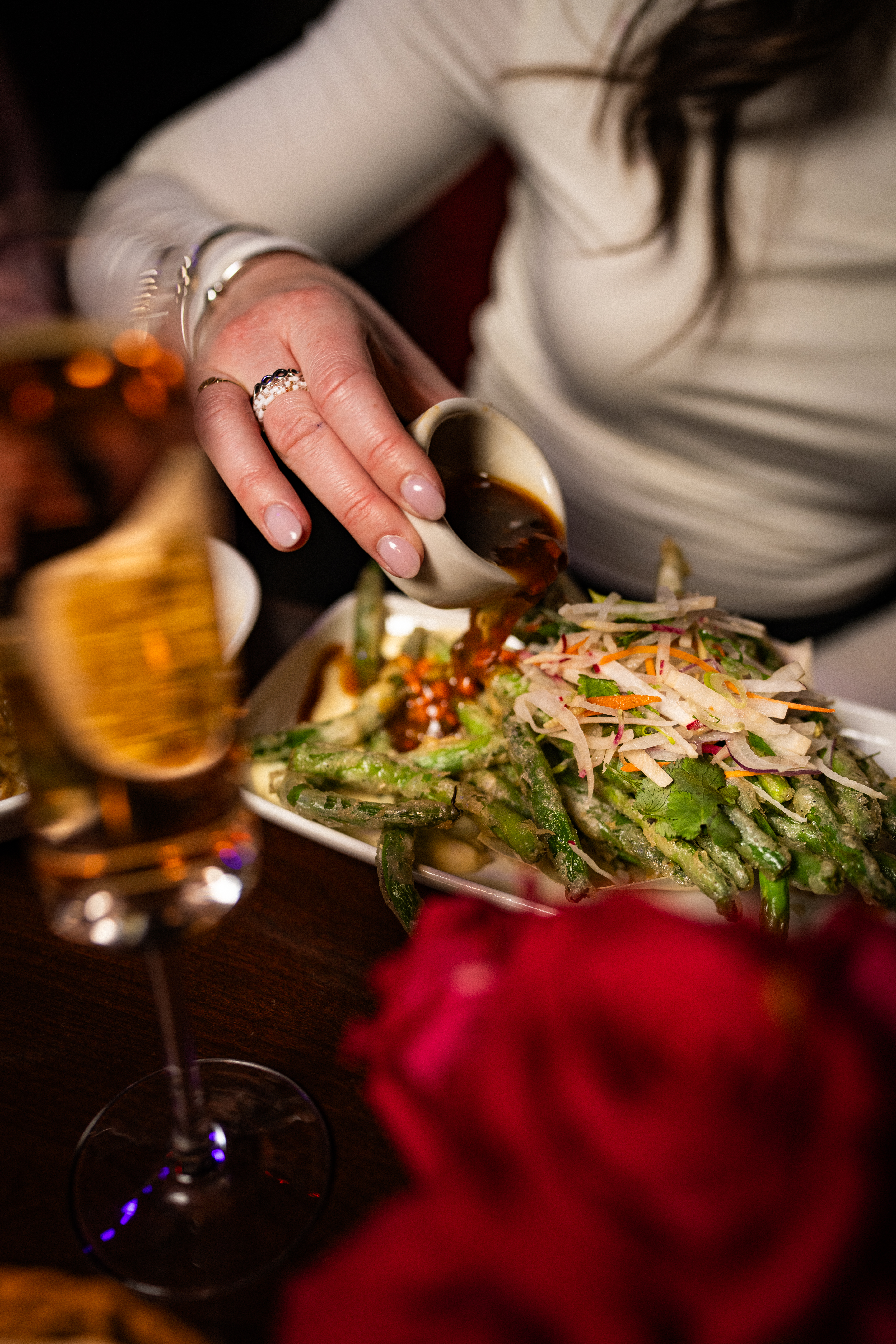 a woman sitting at a table with wine glasses