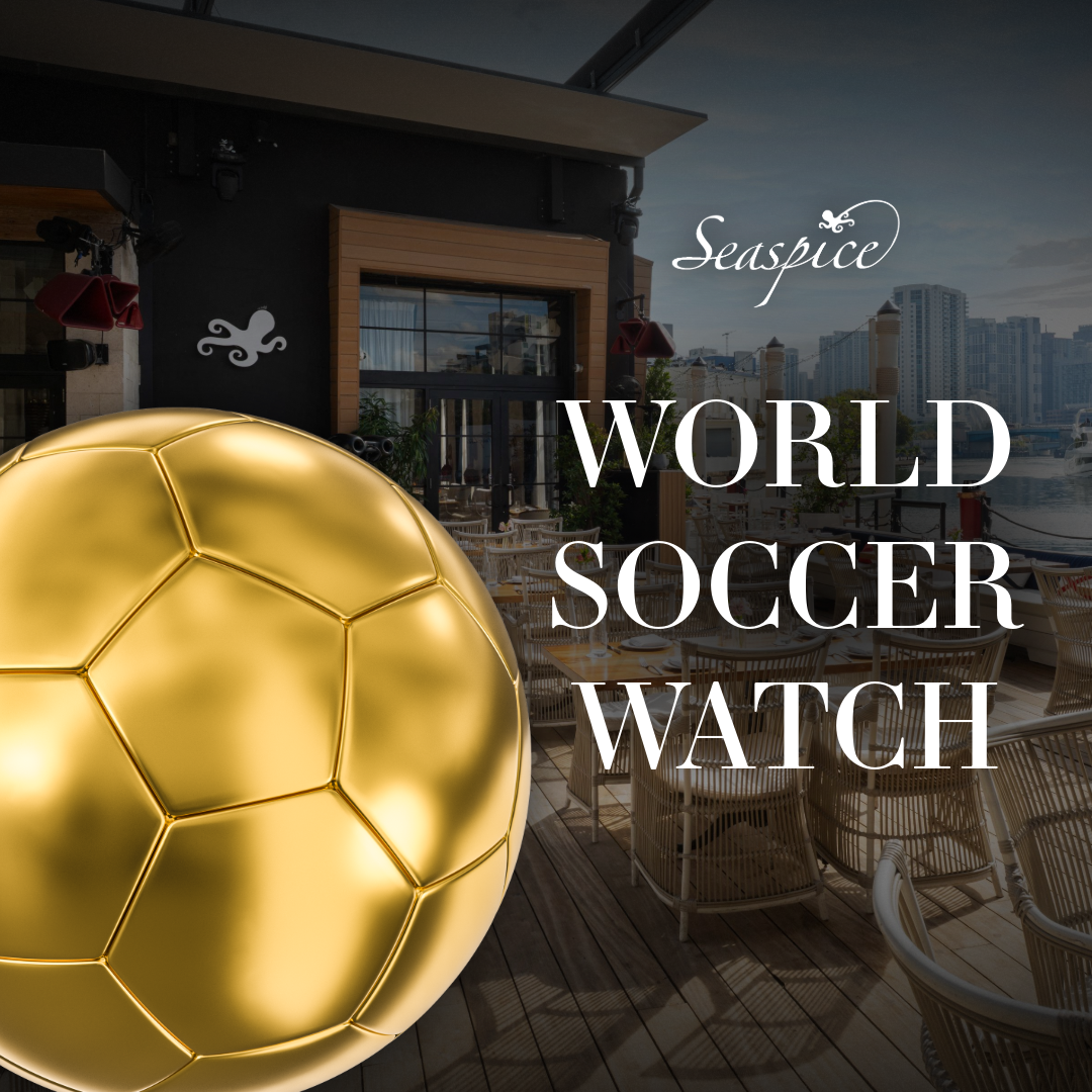 a gold football ball in front of a building