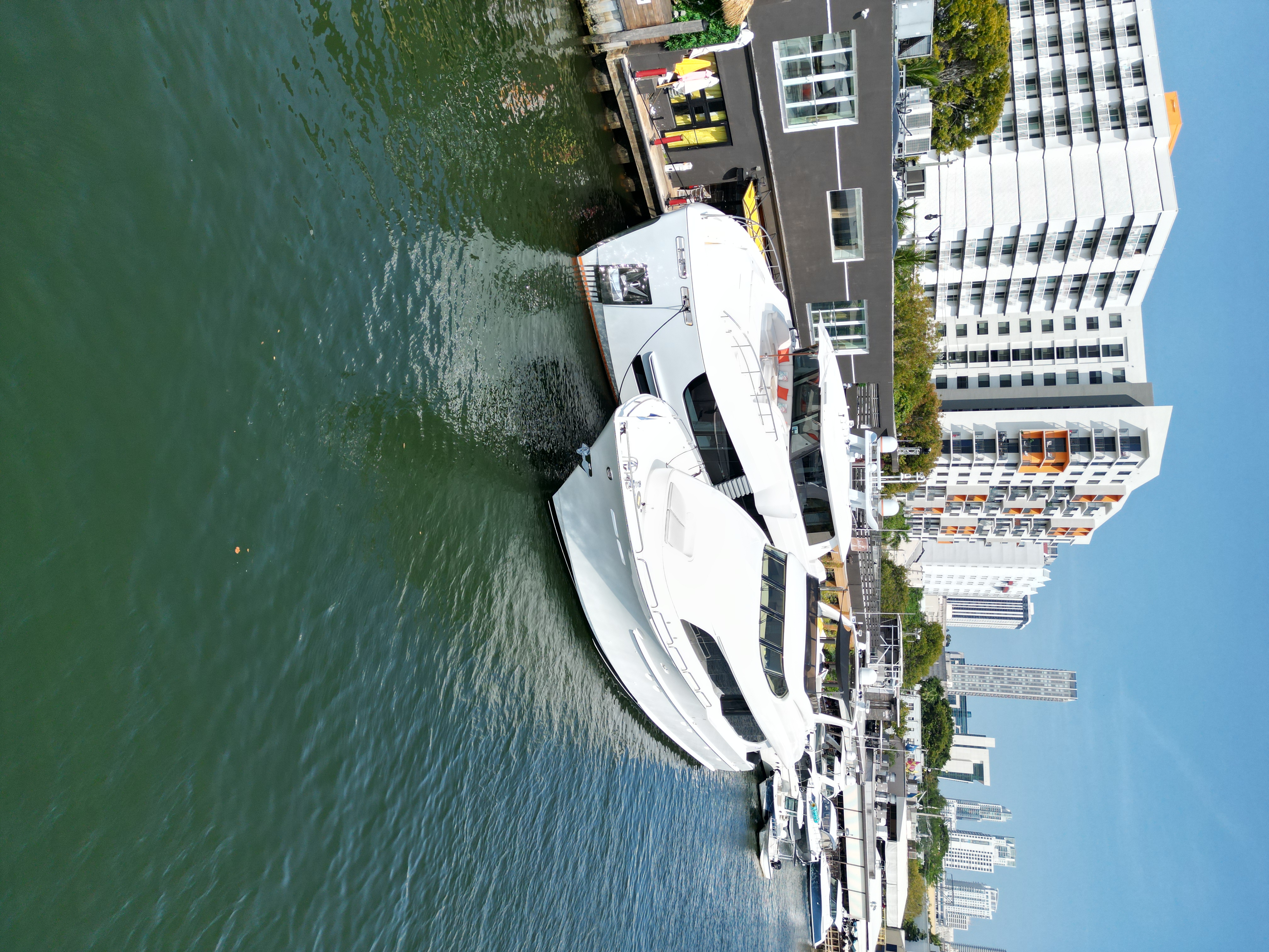 a small boat in a body of water with a city in the background