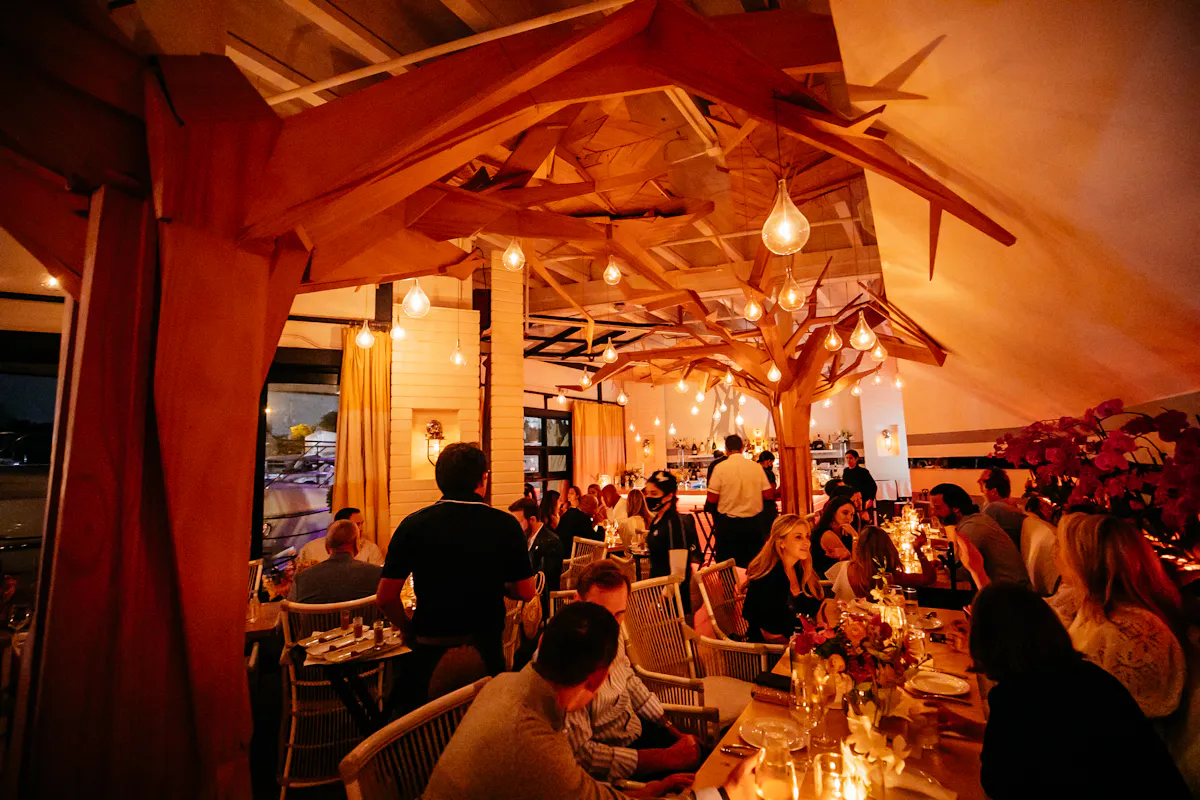 a group of people sitting at a table in a restaurant