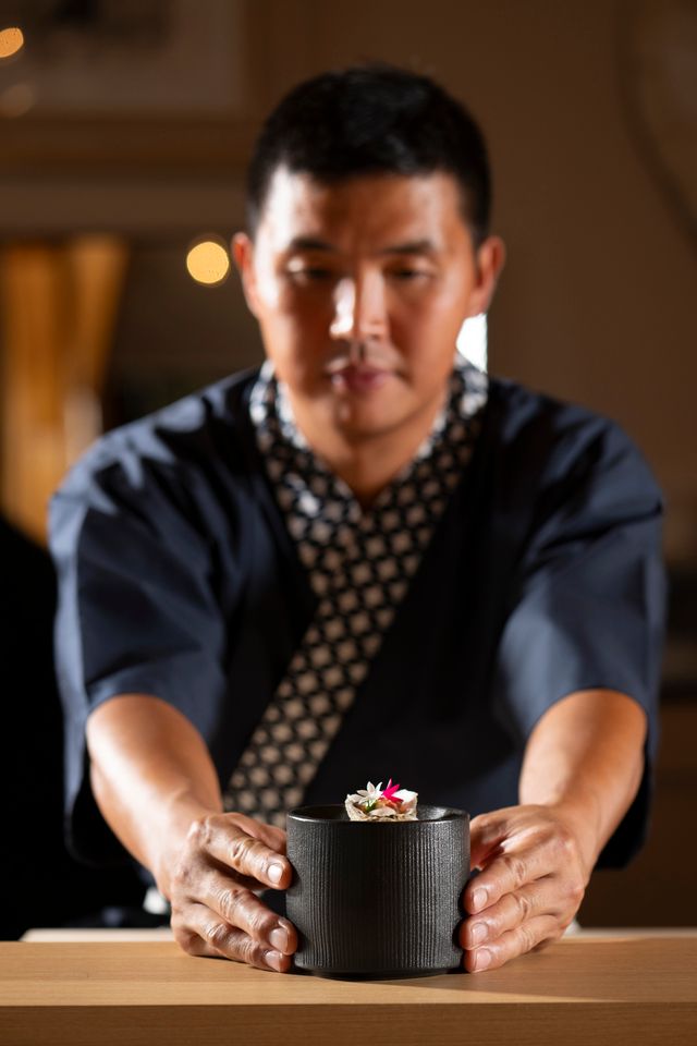 a man holding a bowl of food