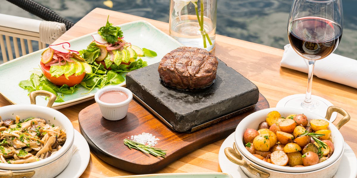 a plate of food and a glass of wine