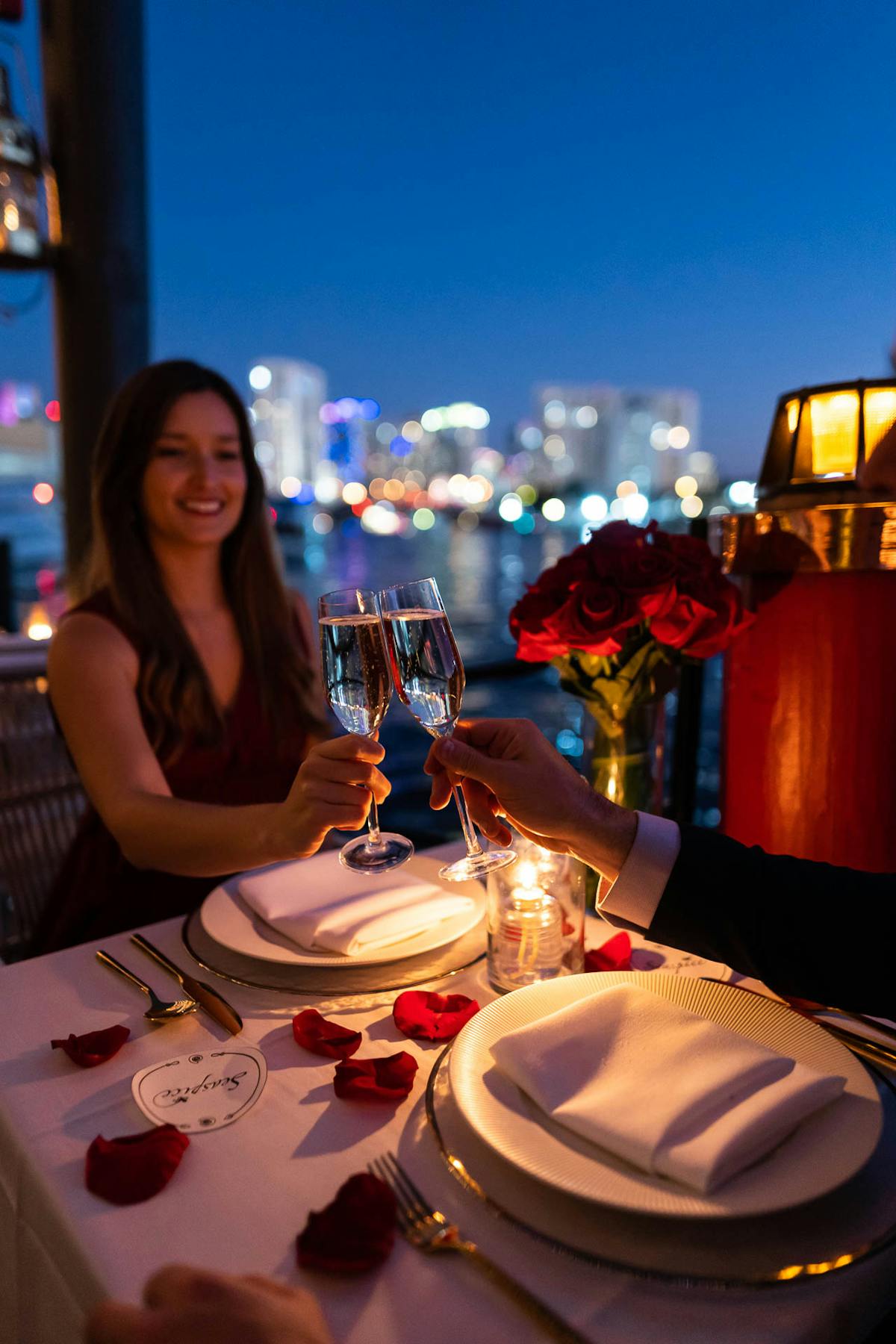 a person sitting at a table with wine glasses