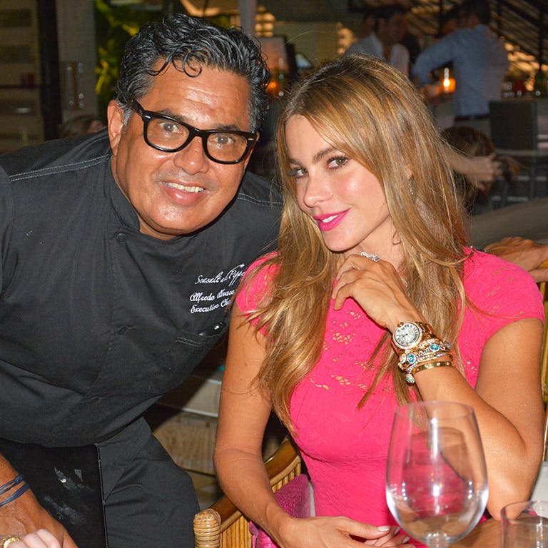 Sofia Vergara et al. sitting at a table with wine glasses