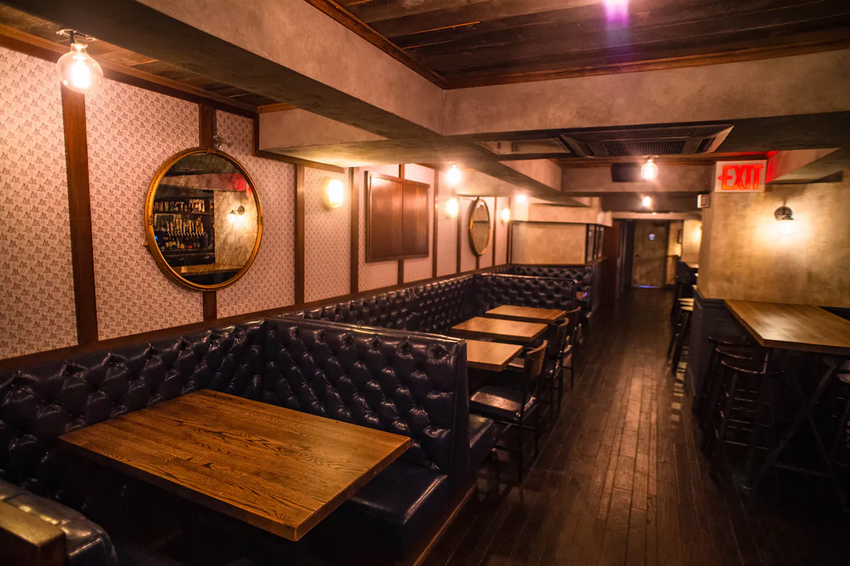a kitchen with a clock at the top of a wooden table