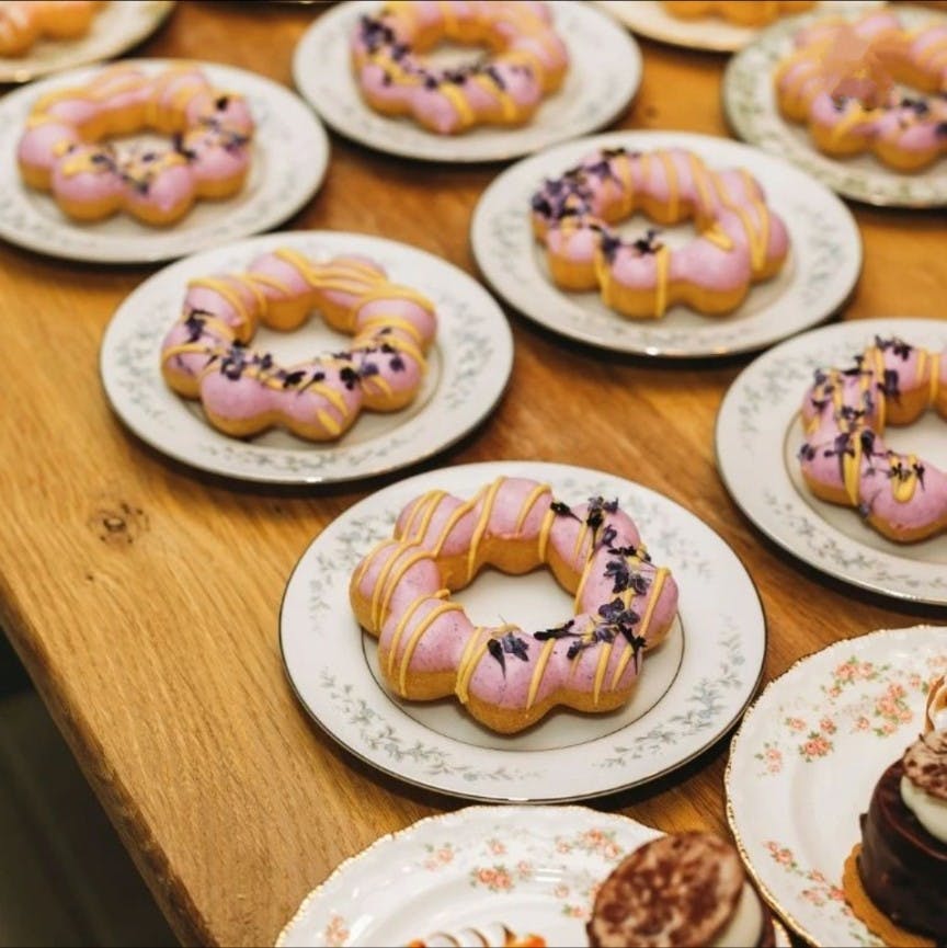 a wooden table topped with plates of food on a plate